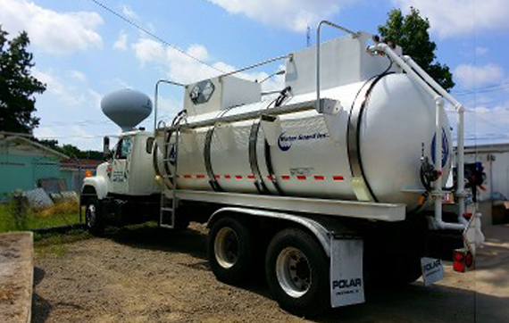 A White Truck With A Large Tank